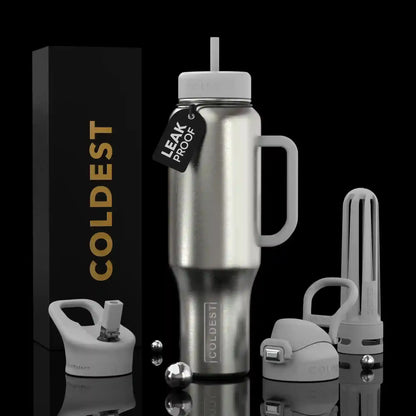 Coldest leak-proof stainless steel tumbler with straw lid, handle, and accessories on black background